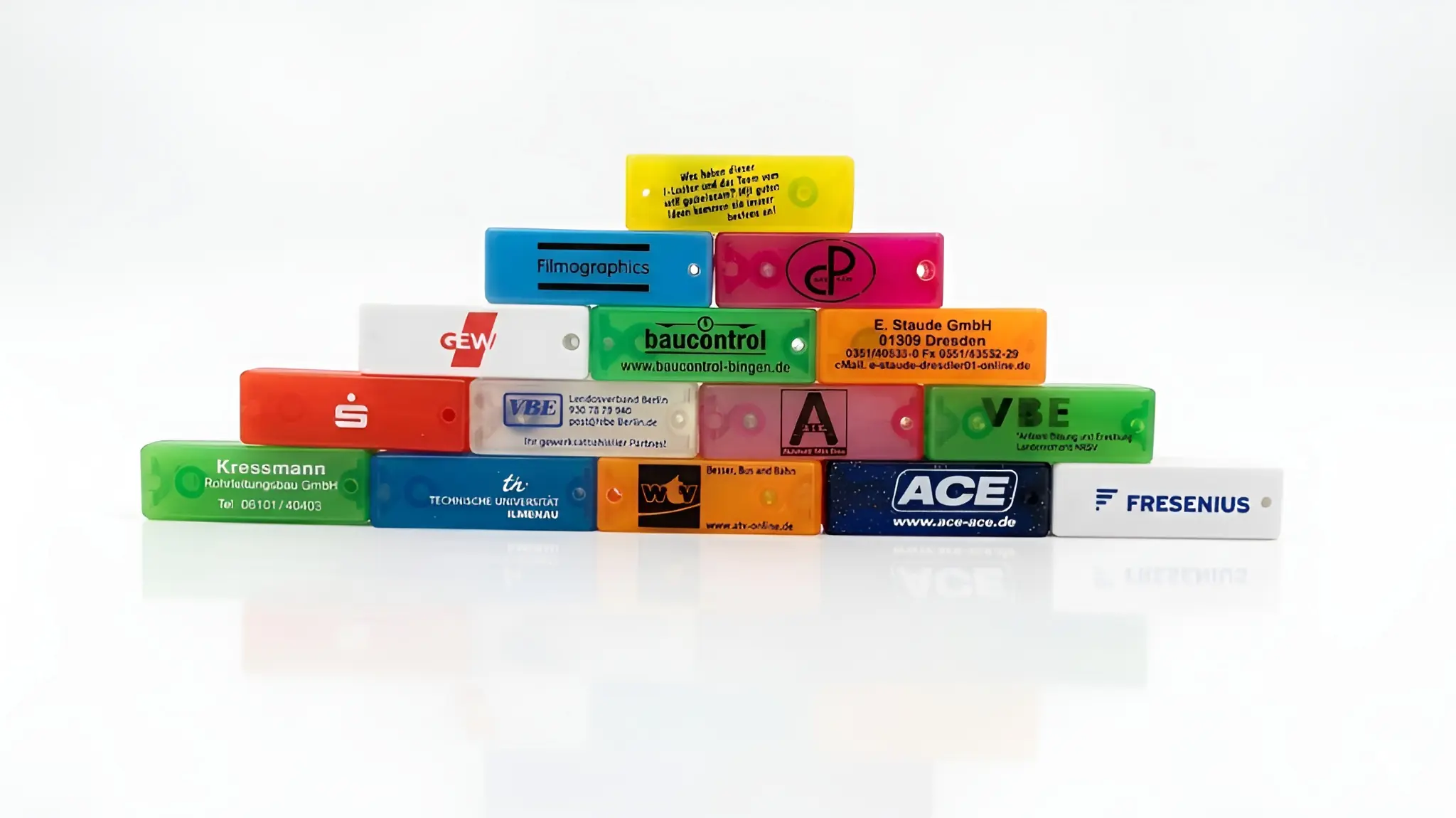 Vielie Minilocher mit Firmenlogos, die in einer Pyramidenform gestapelt wurden.